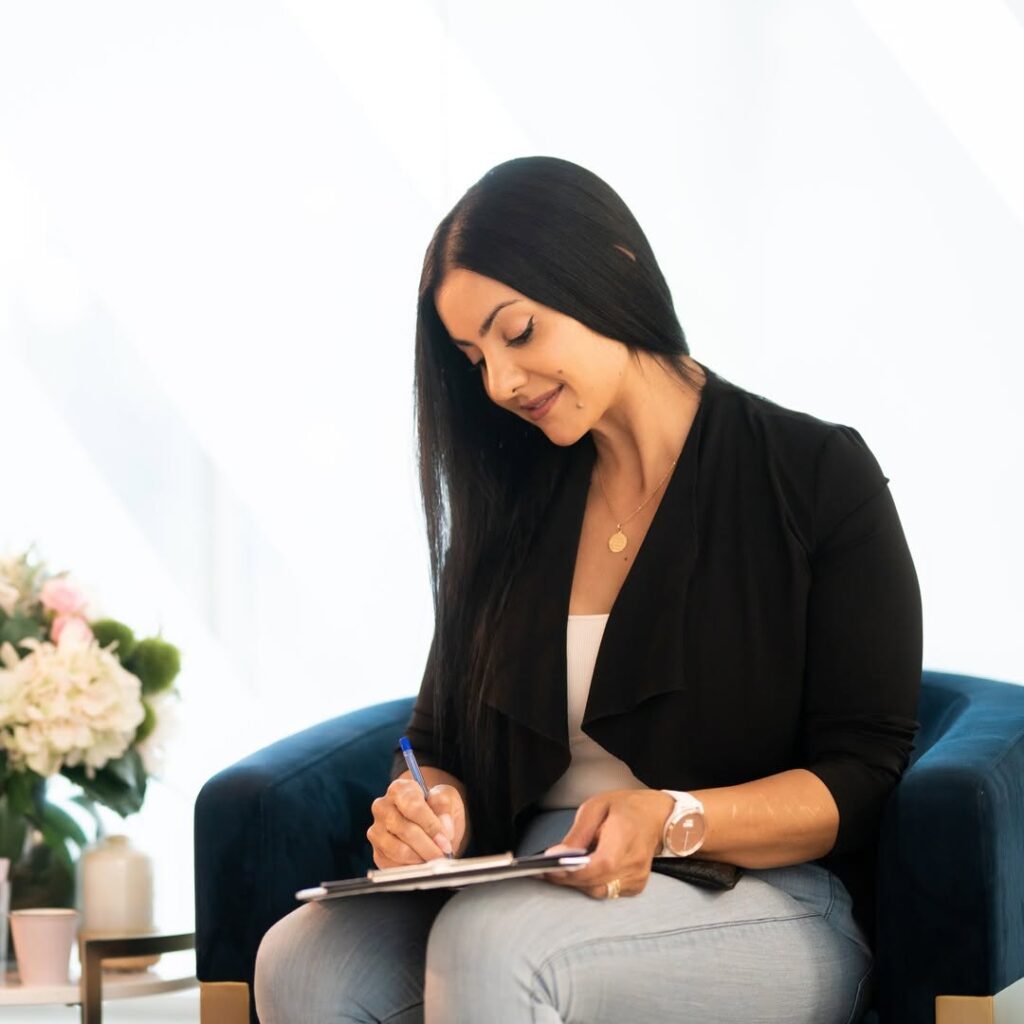 Woman writing on ta paper